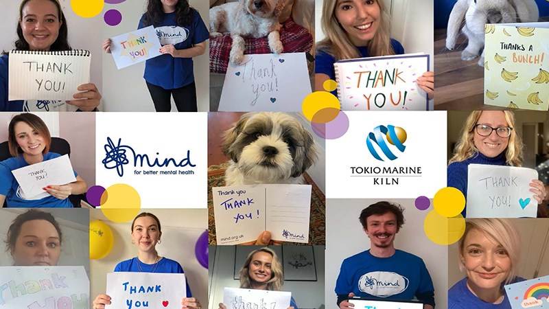 Group picture with "thank you" signs