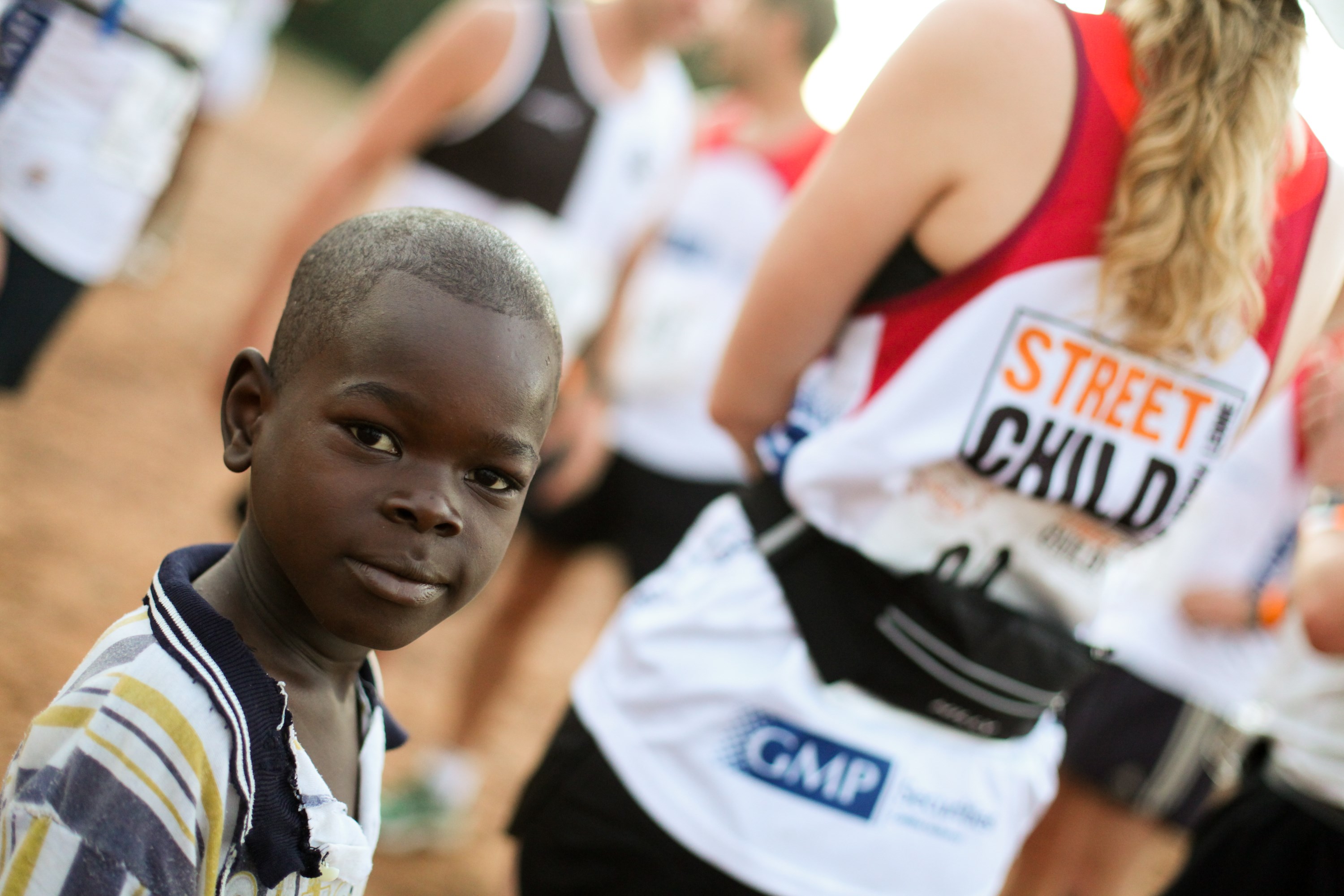 Child and marathon runners