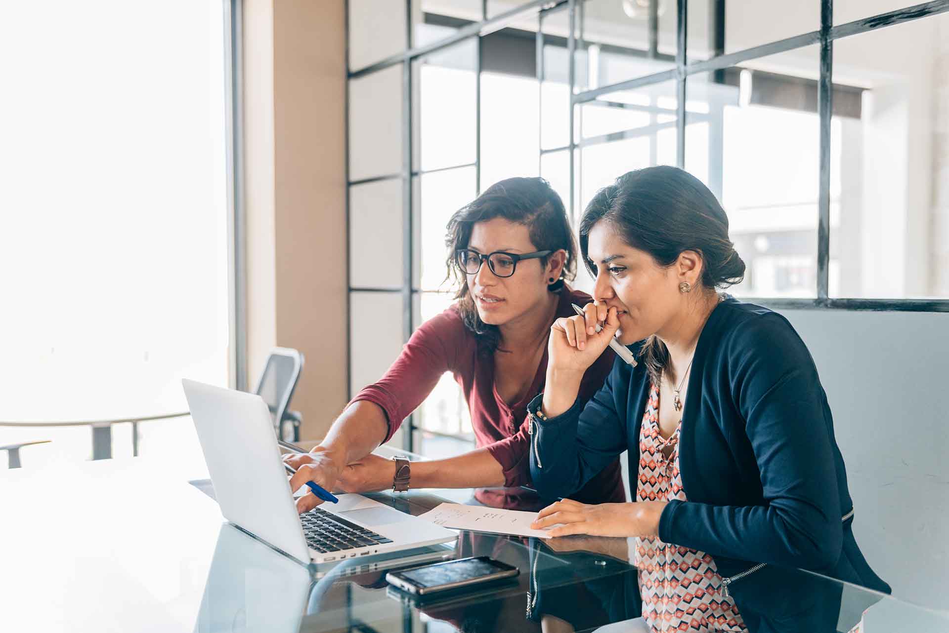 Two women looking at laptop together