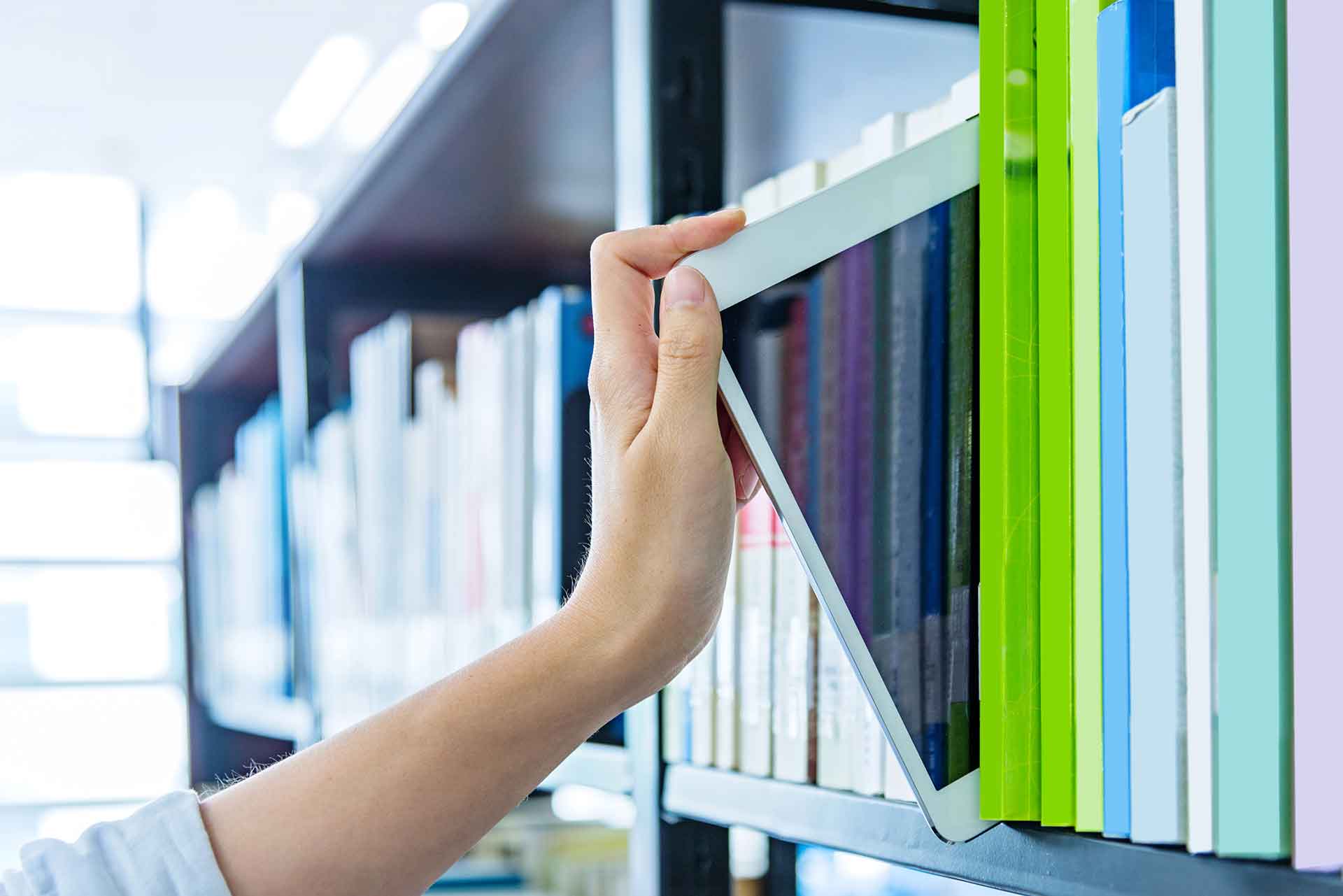 iPad on library shelf with books