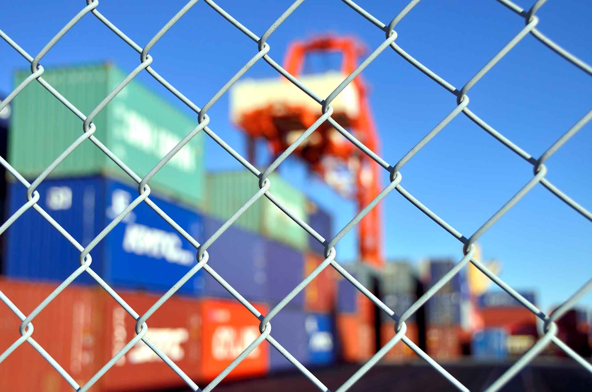 abstract image of containers through fence