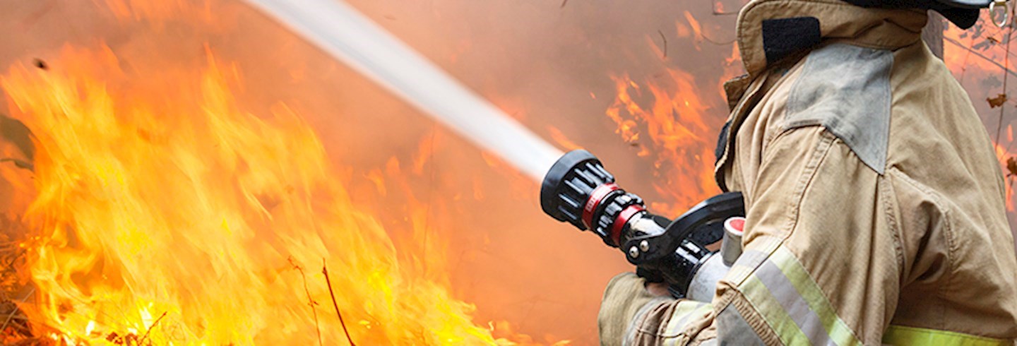 Fireman hosing out fire