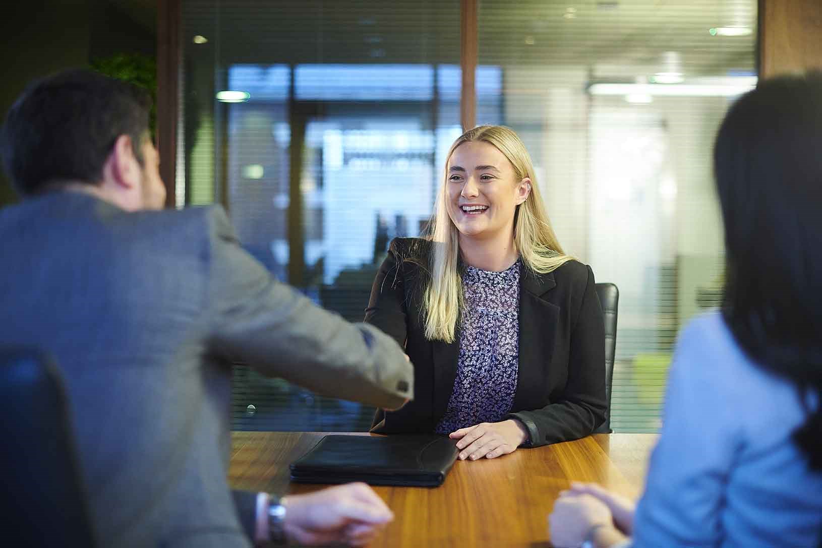Business woman shaking hands with male colleague